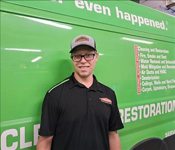 Male technician, standing in front of SERVPRO van