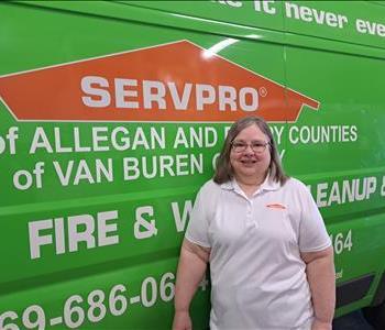 Nannette standing in front of a SERVPRO van