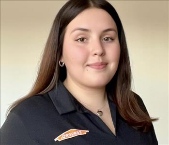 Female employee in front of white wall