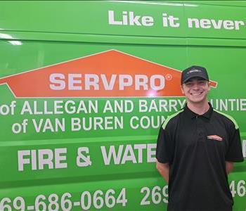 Male employee, Griffin, standing in front of green SERVPRO vehicle