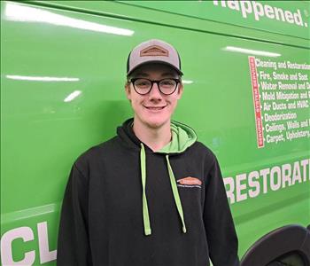 Male technician, standing in front of SERVPRO van