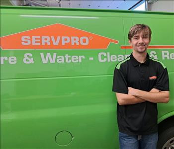 Male technician, standing in front of SERVPRO van