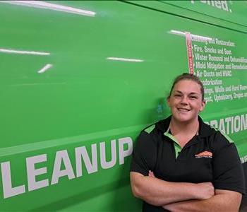 Jordan standing in front of SERVPRO truck