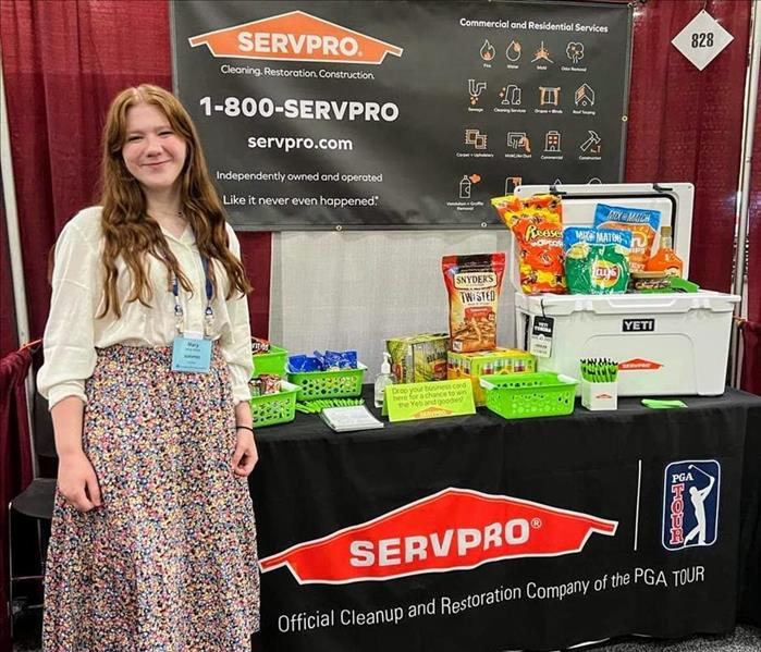 SERVPRO Rep standing in front of table display