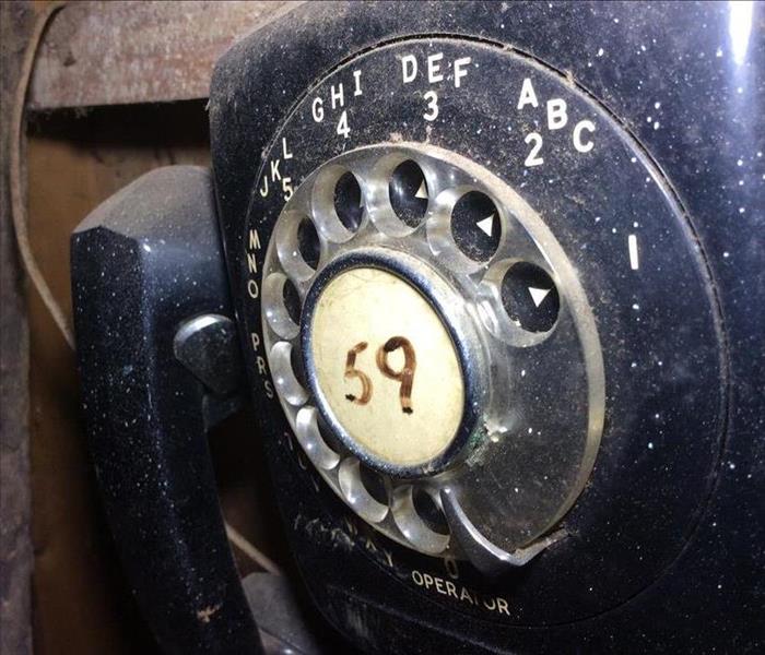 Old telephone covered in mold and soot